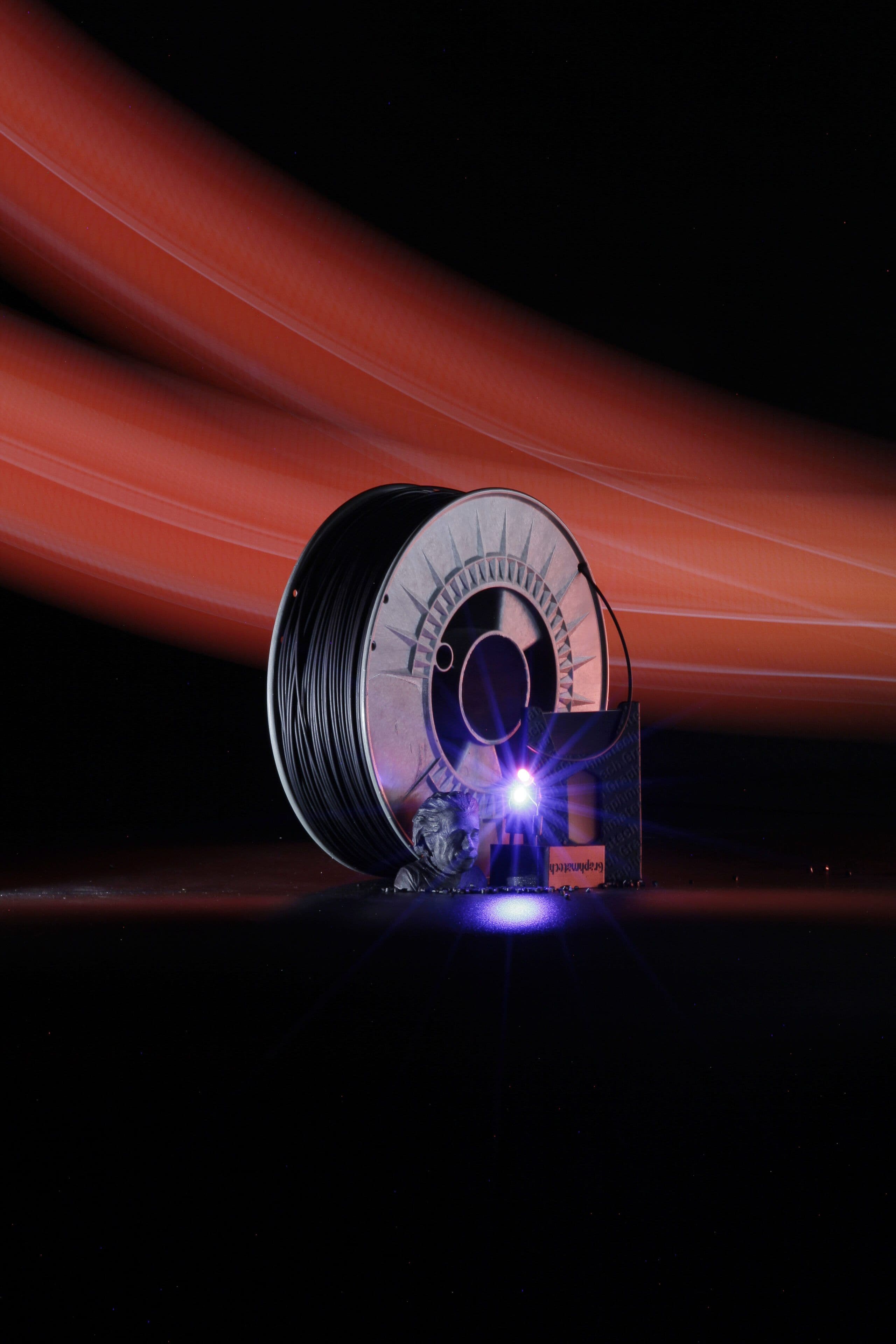 AROS PVDF Conductive 3D printing filament spool with printed functional components demonstrating electrical conductivity. Photo by Johan Inghammar Magnusson.